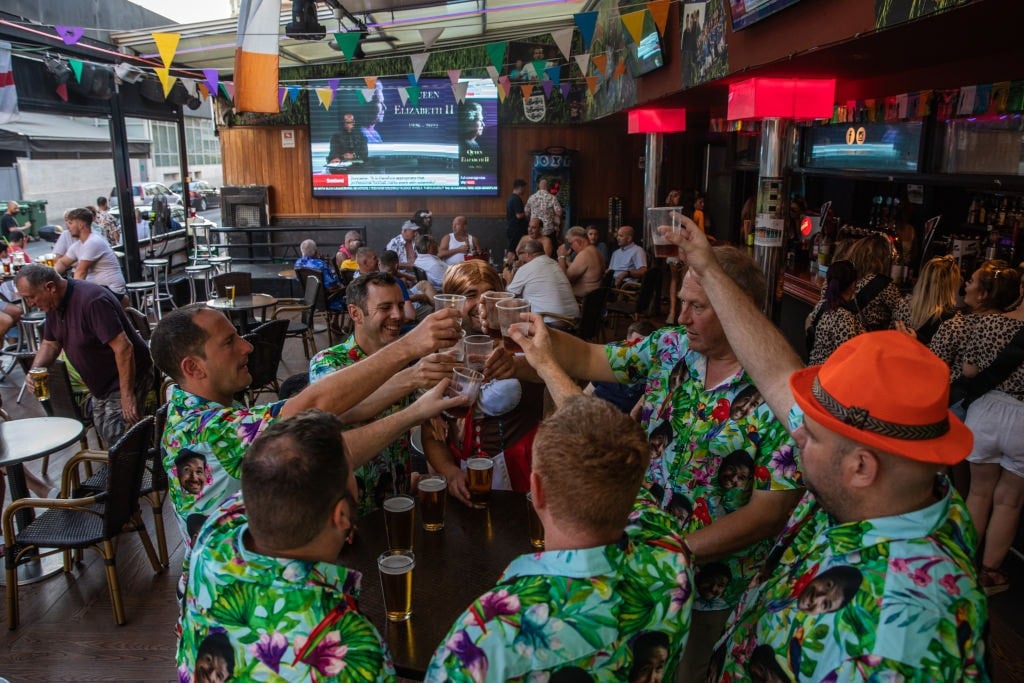 men holding up beer and cheersing