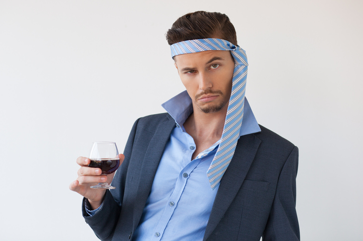 Closeup of drunk man at party in business attire