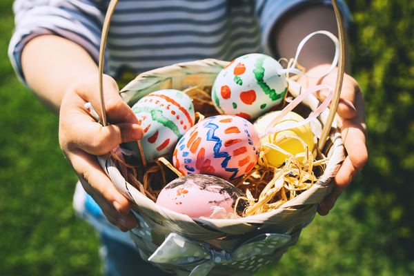 Easter eggs in a basket with a little girl holding them