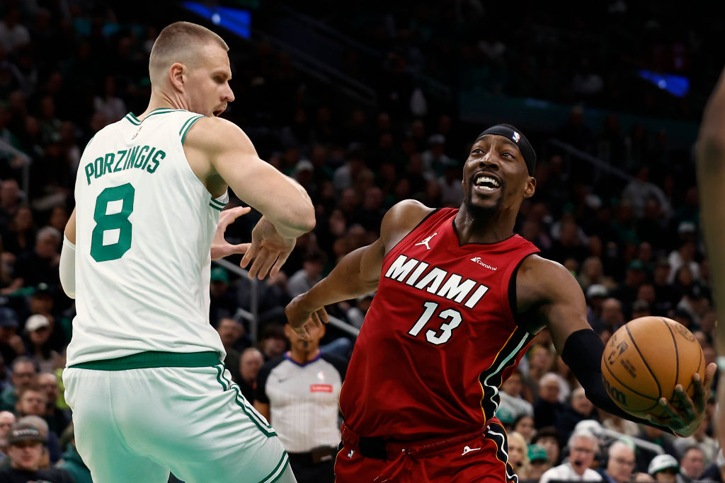 Bam Adebayo sports a silly grin as he's defended by Kristaps Porzingas in the Celtics Heat Playoffs Game 1